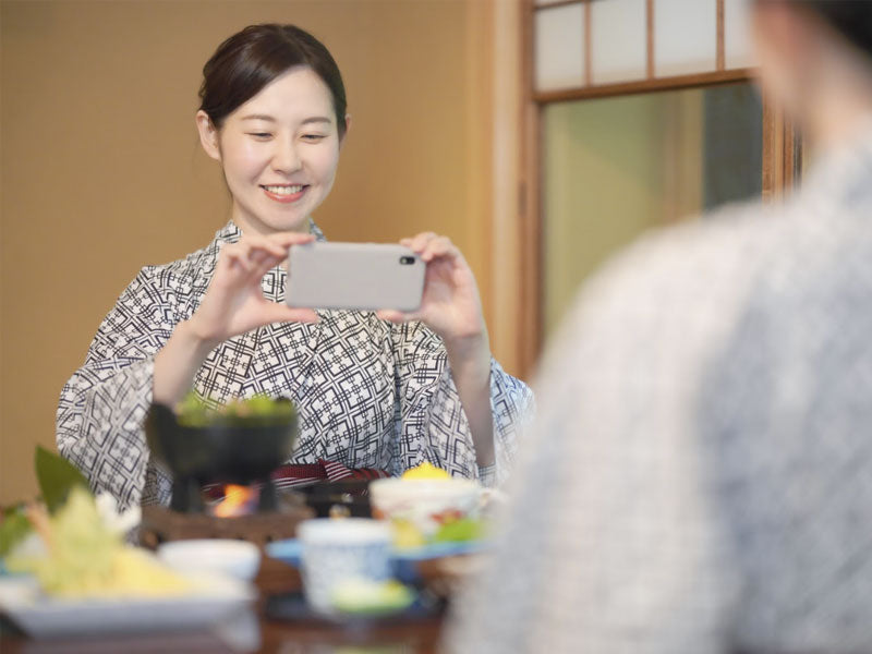 japanese in kimono taking food pictures