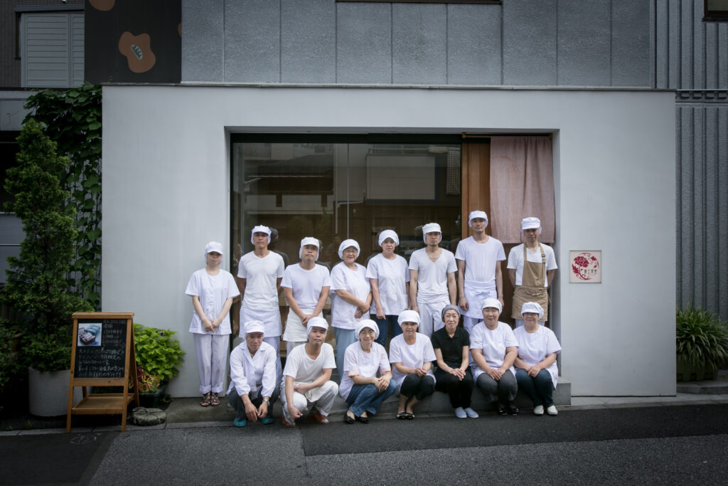 A group of staff of a rice cracker shop in Tokyo